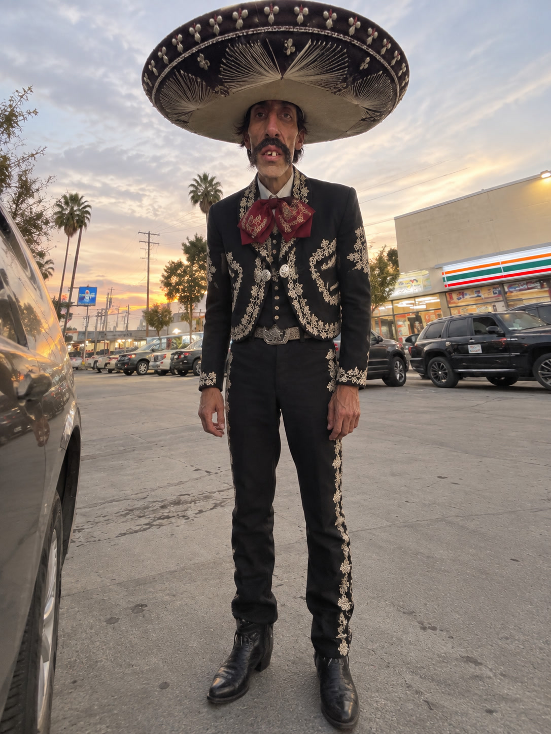 El Sombrerón in his embroidered charro suit and sombrero, at dusk